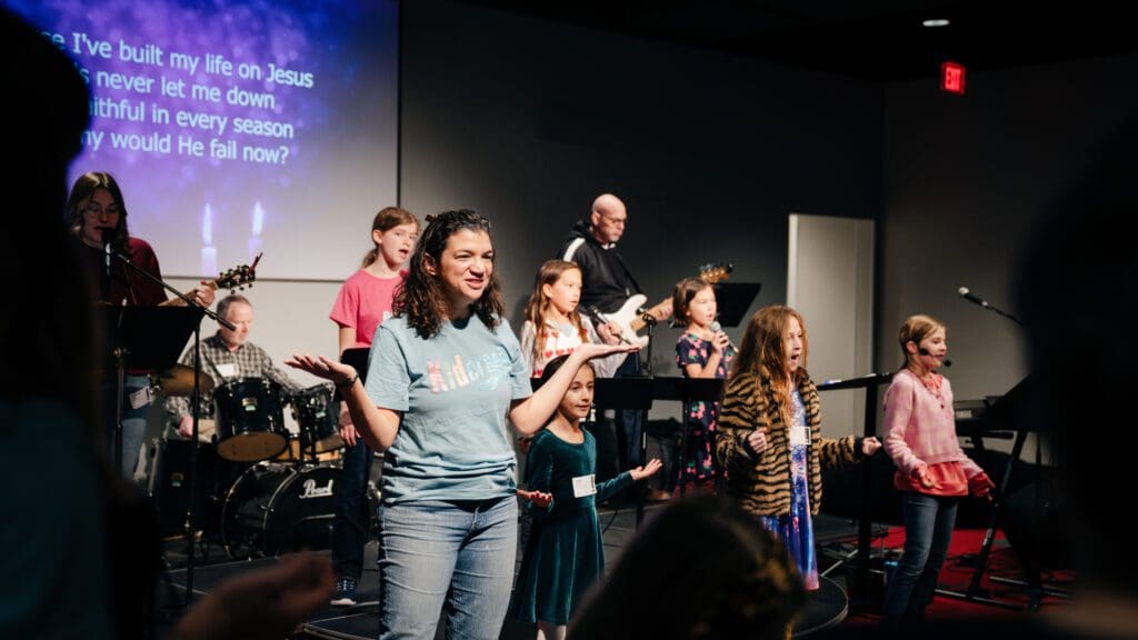 A group of people standing in front of a stage.