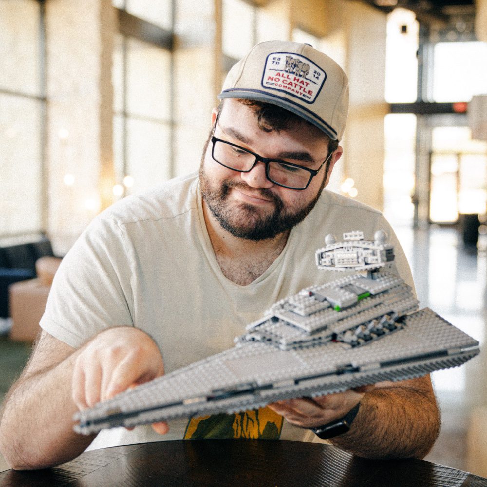 A man holding a model of the star destroyer.