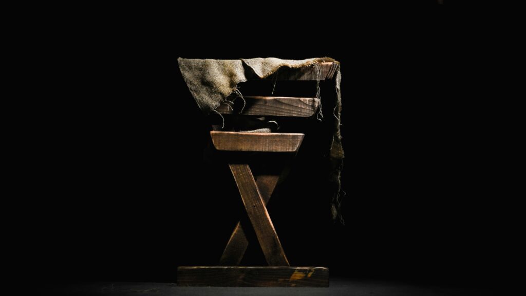 Wooden manger with burlap cloth.