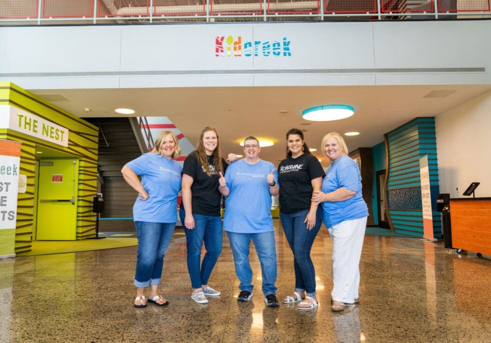 Five women smiling in front of KidCreek.